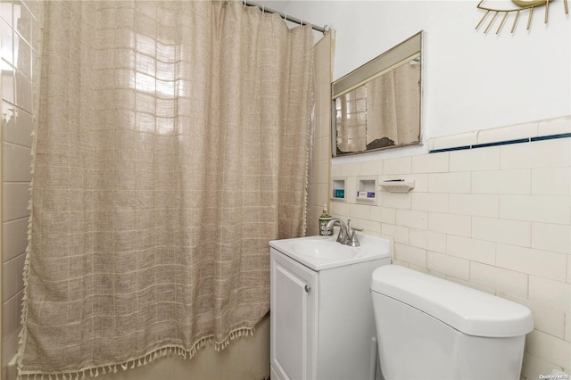 full bathroom featuring vanity, toilet, shower / bathtub combination with curtain, and tile walls