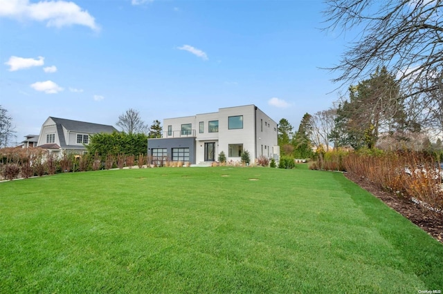 rear view of property with a lawn