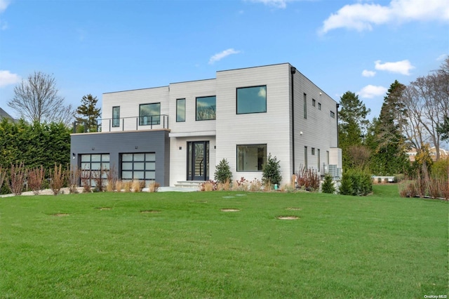 view of front of property featuring a balcony and a front yard