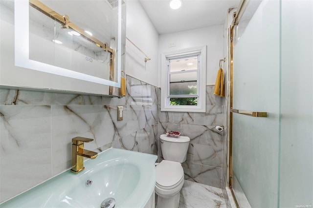 bathroom with toilet, tile walls, and sink