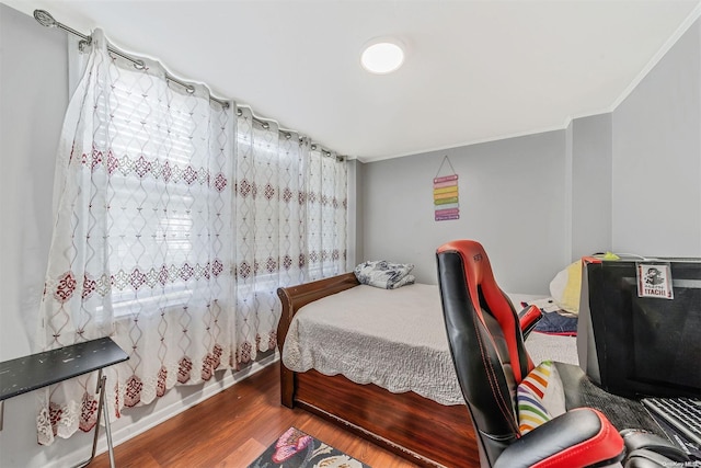 bedroom with crown molding and hardwood / wood-style floors