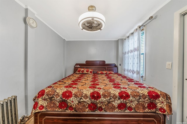 bedroom with crown molding and radiator heating unit