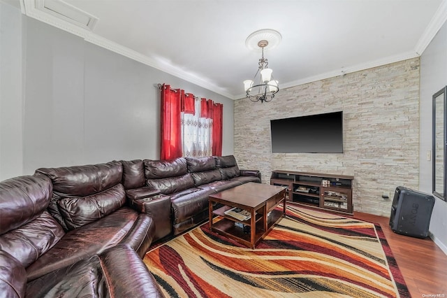 living room featuring hardwood / wood-style floors, ornamental molding, and a notable chandelier