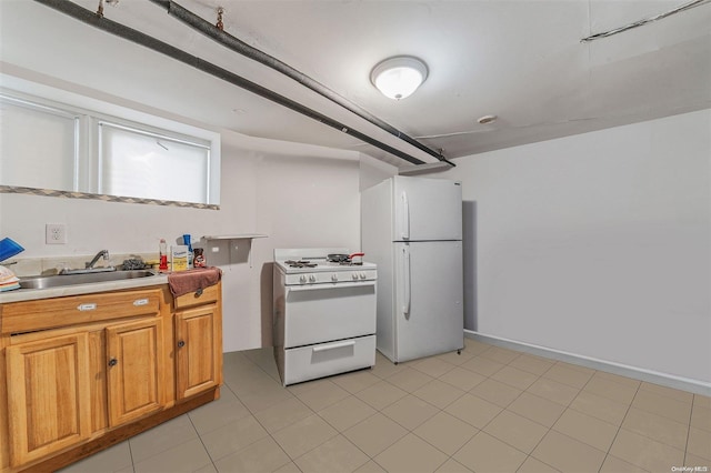 kitchen with light tile patterned flooring, white appliances, and sink