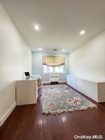 interior space with radiator and dark wood-type flooring