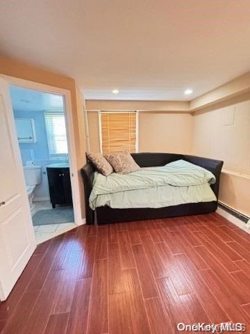 bedroom featuring wood-type flooring and ensuite bathroom