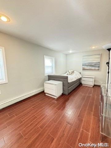 unfurnished bedroom with dark wood-type flooring