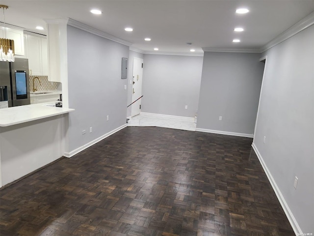 interior space featuring dark parquet flooring, crown molding, and sink