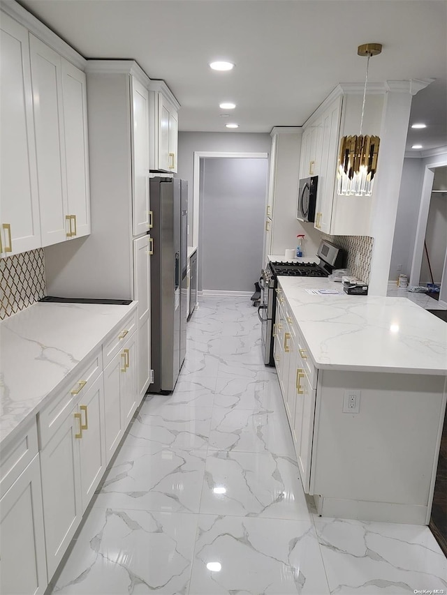 kitchen with light stone counters, white cabinets, stainless steel appliances, and decorative light fixtures