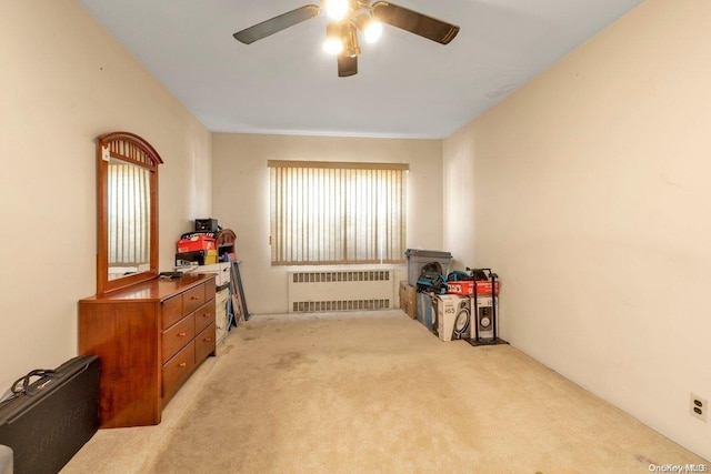 miscellaneous room featuring light carpet, radiator heating unit, and ceiling fan