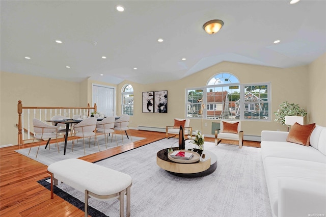 living room with light hardwood / wood-style floors and vaulted ceiling