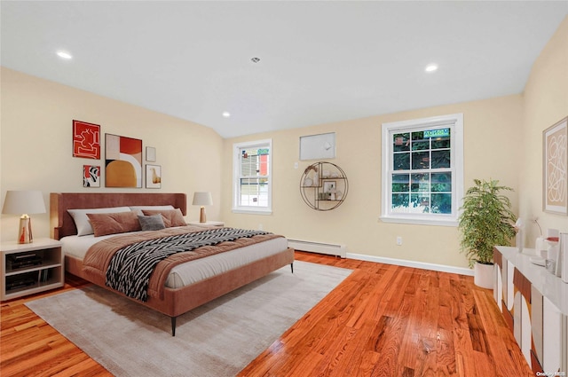 bedroom featuring baseboard heating and light wood-type flooring