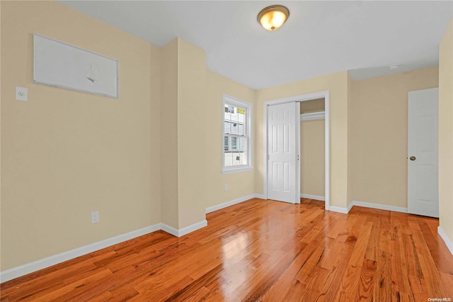 unfurnished bedroom featuring a closet and light hardwood / wood-style flooring