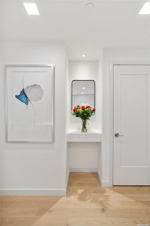 hallway with light hardwood / wood-style flooring