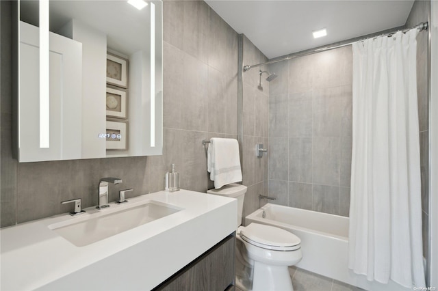 full bathroom with vanity, tile patterned floors, decorative backsplash, shower / bath combo with shower curtain, and tile walls