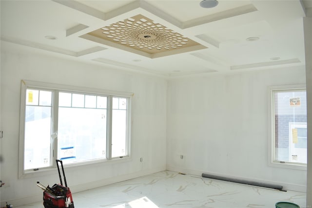 empty room featuring a healthy amount of sunlight and coffered ceiling