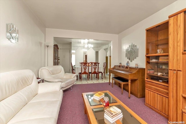 living room featuring a chandelier and carpet floors