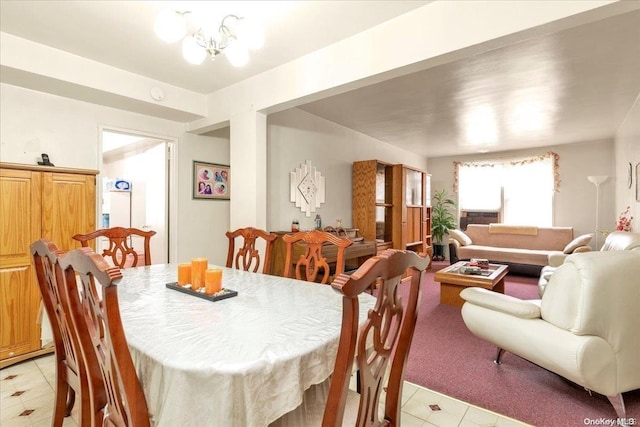 carpeted dining room with a notable chandelier