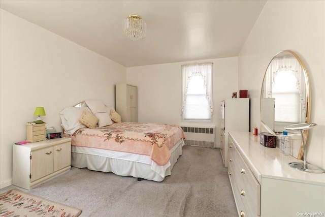 bedroom featuring radiator and light colored carpet