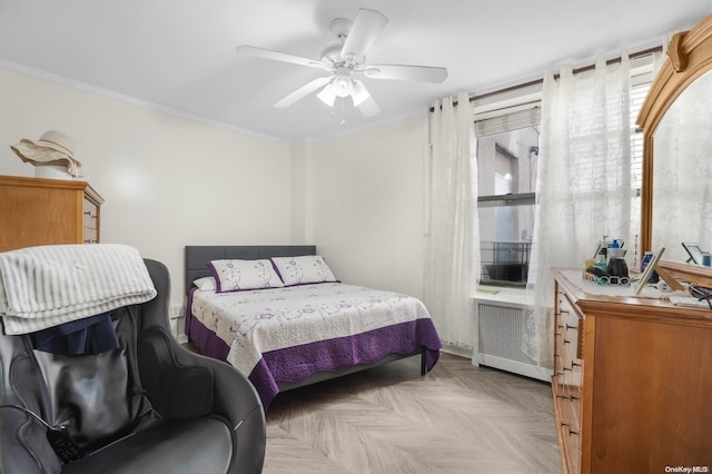 bedroom with radiator, ceiling fan, light parquet flooring, and ornamental molding