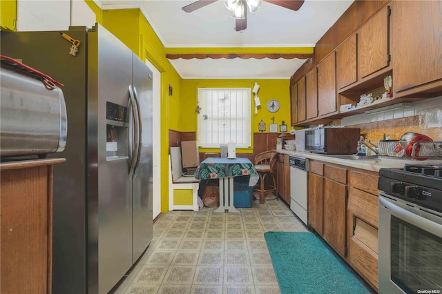 kitchen with backsplash, stainless steel appliances, ceiling fan, and crown molding