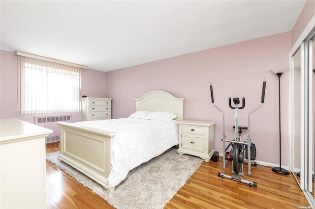 bedroom with radiator and wood-type flooring