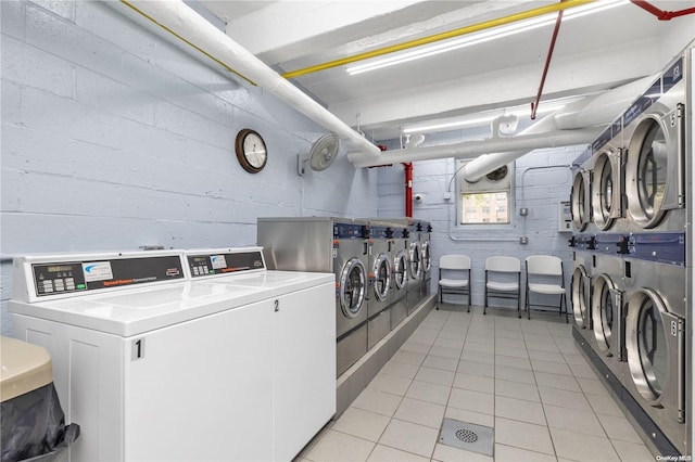 laundry room with separate washer and dryer and light tile patterned floors