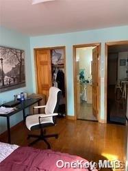 bedroom with wood-type flooring and ensuite bathroom