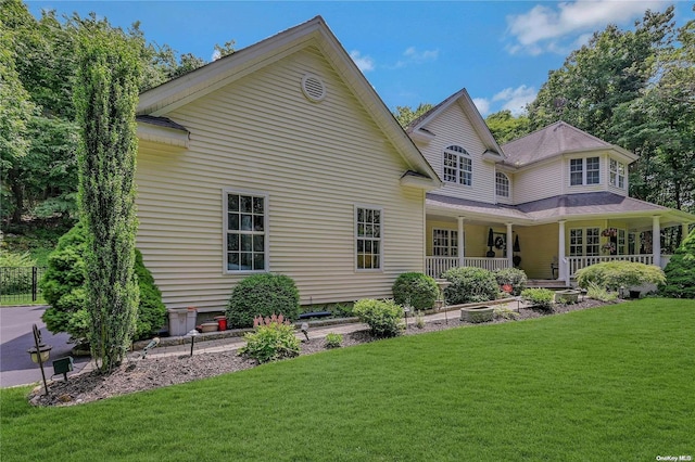 22 Saints Orchard Rd, Port Jefferson, NY 11777 - back of property with a yard and a porch