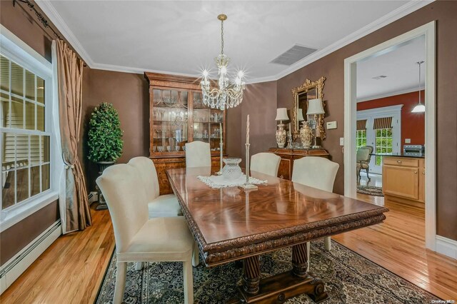 22 Saints Orchard Rd, Port Jefferson, NY 11777 - dining space with a baseboard heating unit, a chandelier, light wood-type flooring, crown molding, and baseboards