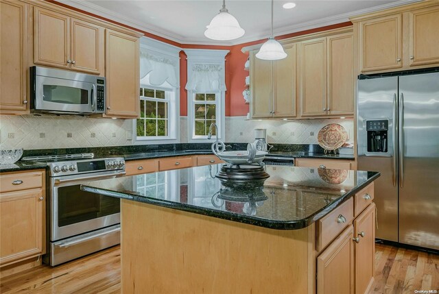22 Saints Orchard Rd, Port Jefferson, NY 11777 - kitchen with appliances with stainless steel finishes, a center island, light wood finished floors, dark stone countertops, and pendant lighting