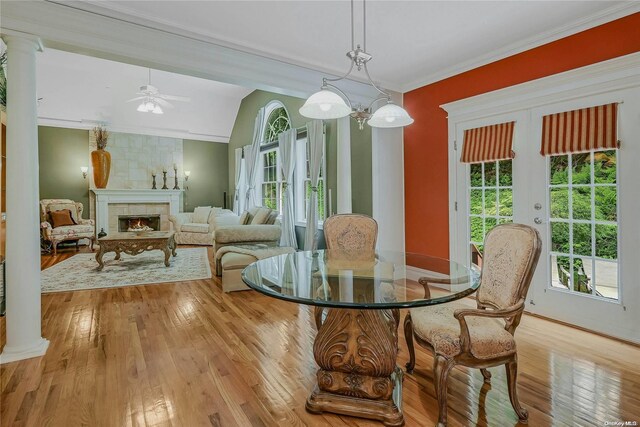22 Saints Orchard Rd, Port Jefferson, NY 11777 - dining area with wood-type flooring, ceiling fan, a fireplace, vaulted ceiling, and baseboards