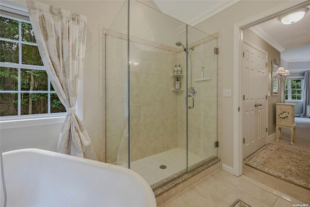 22 Saints Orchard Rd, Port Jefferson, NY 11777 - ensuite bathroom with crown molding, a freestanding bath, a shower stall, tile patterned flooring, and baseboards