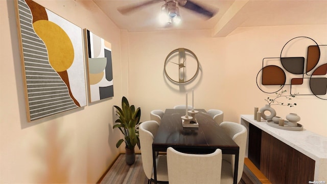 dining area featuring ceiling fan and beamed ceiling