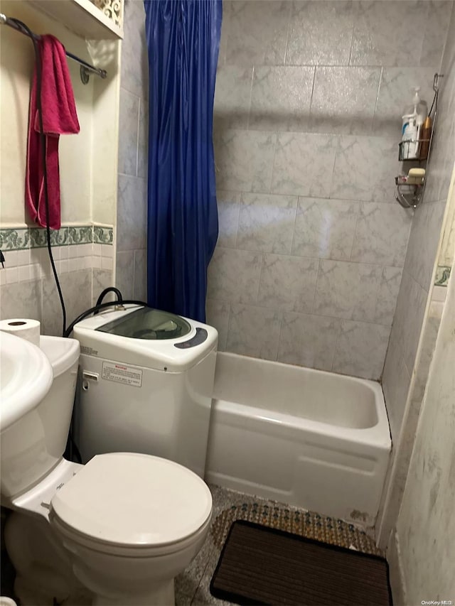 bathroom featuring shower / bath combination with curtain, toilet, and tile walls