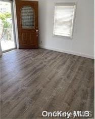 unfurnished dining area featuring dark hardwood / wood-style flooring