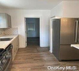 kitchen featuring dark hardwood / wood-style floors and backsplash