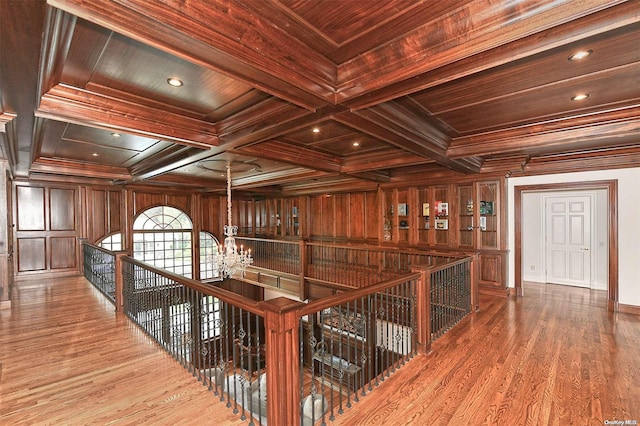 corridor with beamed ceiling, hardwood / wood-style flooring, and wood ceiling