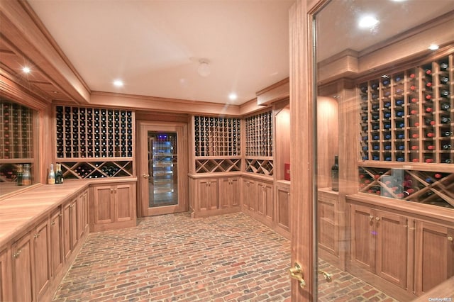 wine cellar featuring ornamental molding