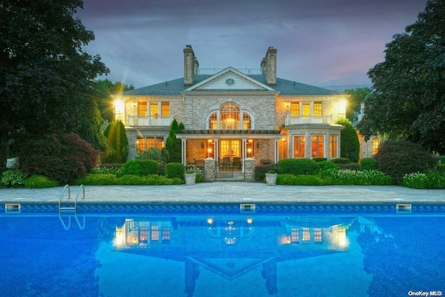 view of pool at dusk