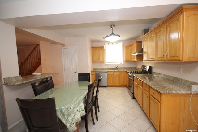 kitchen with light stone counters, stainless steel appliances, sink, exhaust hood, and light tile patterned floors