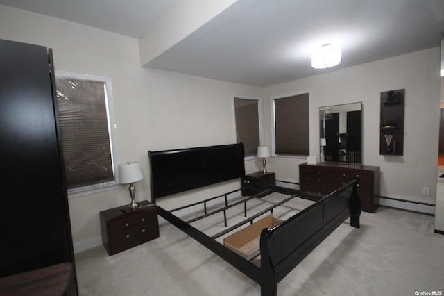 bedroom featuring light carpet and a baseboard heating unit