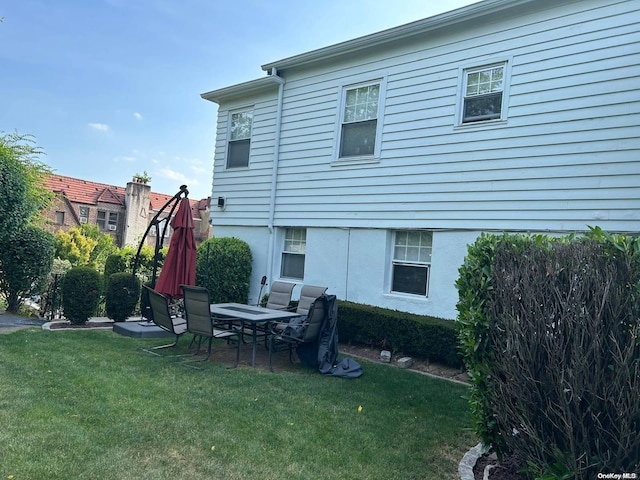 back of house with a lawn