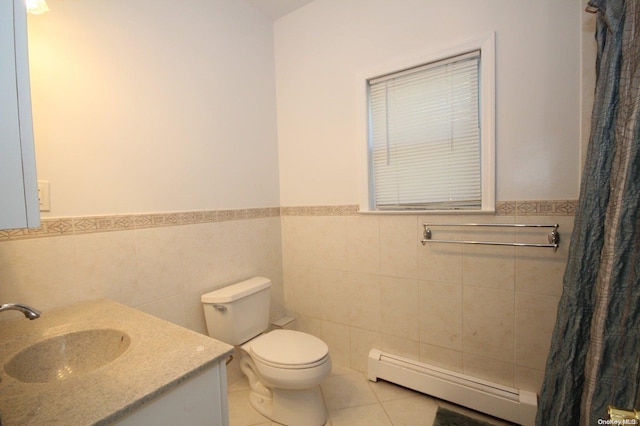 bathroom featuring vanity, tile patterned floors, toilet, tile walls, and a baseboard radiator