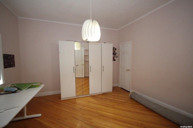 bedroom with crown molding and hardwood / wood-style floors