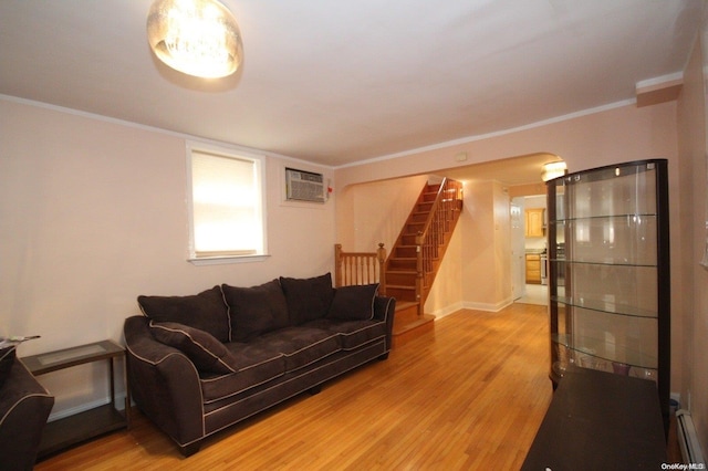 living room with hardwood / wood-style floors, crown molding, and a wall mounted AC