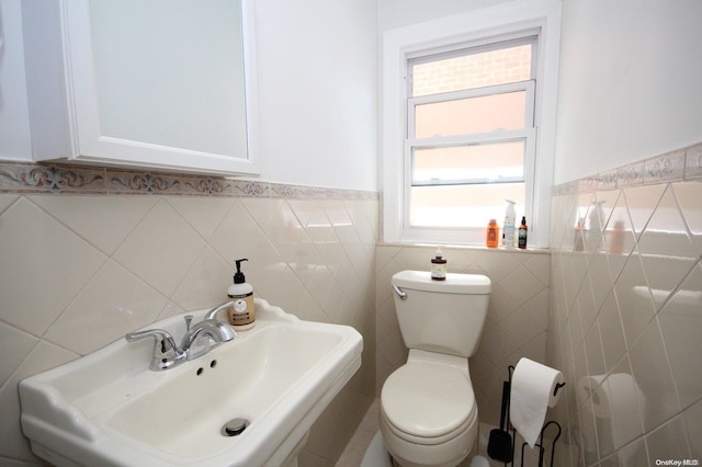 bathroom with sink and tile walls