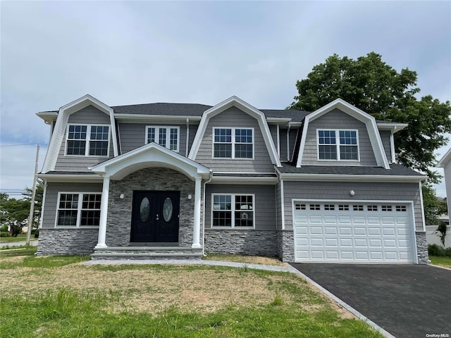 view of front of property with a front lawn and a garage