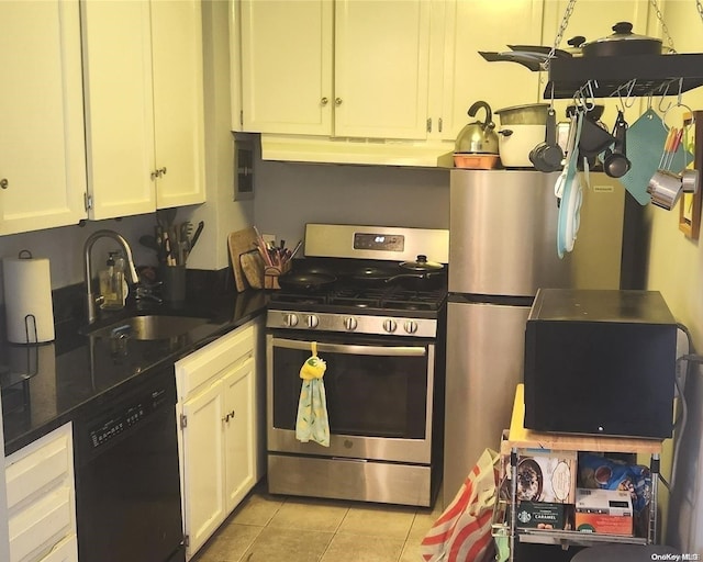 kitchen featuring white cabinets, light tile patterned flooring, sink, and appliances with stainless steel finishes