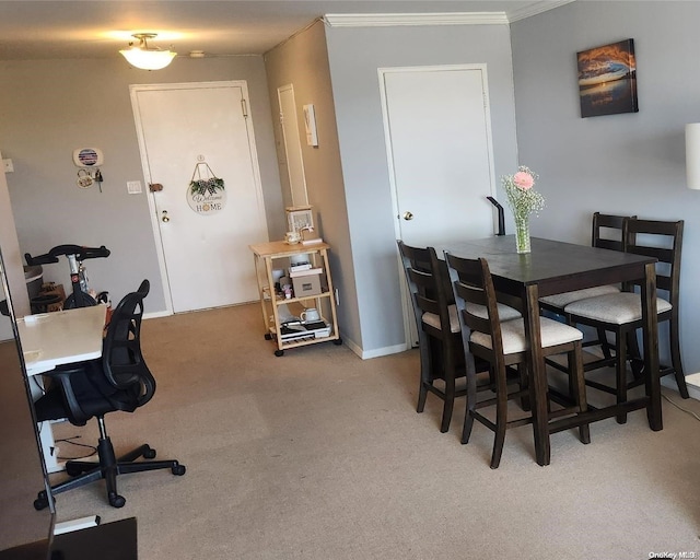 carpeted dining space featuring crown molding